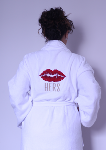 Woman wearing cotton bathrobe with icon of lips on the back. 
